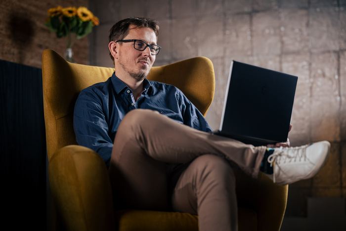 Frank van Delden working from an armchair at home